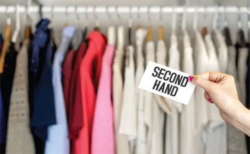 Second-hand clothing being showcased on a rack.